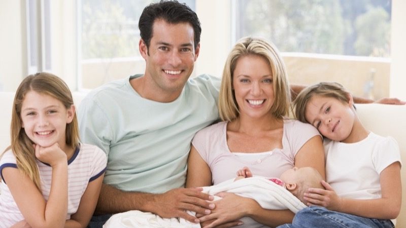 Motiv: Familie med tre børn i en sofa