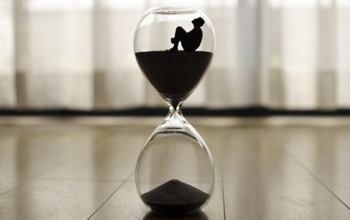 timeglas med person fanget i sandet